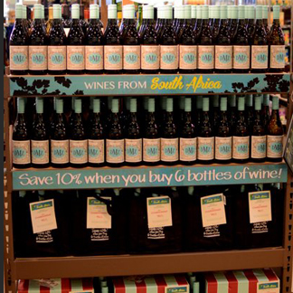 assorted printed materials used to promote the top ten seasonal wines on a display featuring bottles, six packs, and cases
